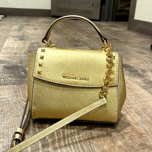 Michael Kors gold small bag with removable crossbody straps.